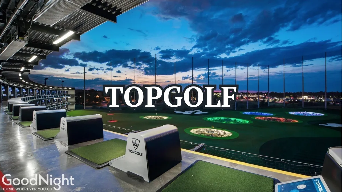 The lively Topgolf building with its distinctive golfing bays and colorful target areas, offering a backdrop of the Nashville skyline. People are golfing, socializing, and dining, conveying an atmosphere of excitement and celebration.