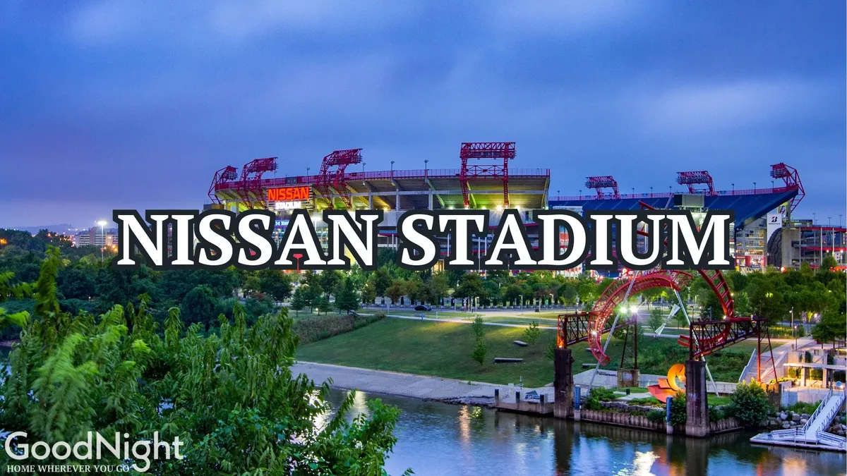 A vibrant exterior shot showcasing Nissan Stadium, surrounded by lush greenery and bordered by the river. The stadium stands prominently, capturing the buzz of game day and the vibrant energy of sports events and concerts held at this major venue.