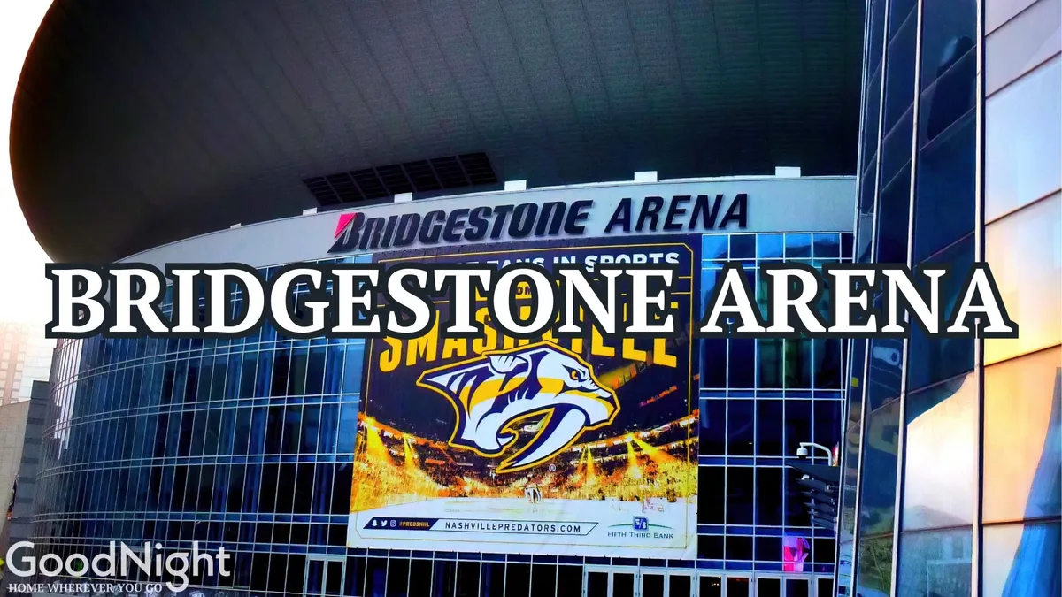 This exterior image features the iconic Bridgestone Arena sign, a large promotional banner, and the sleek, modern architecture of the venue. People can be seen gathering around the entrance, contributing to an atmosphere of excitement and anticipation for live events.